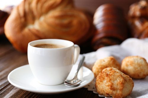 Cup of coffee and different bakery products.